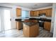 Bright kitchen with wood cabinets, stainless steel appliances, granite counters, and tile floors at 3440 Crystal Tower St, Las Vegas, NV 89129