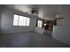 Bright living room with large windows, herringbone tile floors, and view to kitchen at 3440 Crystal Tower St, Las Vegas, NV 89129