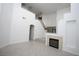 Spacious living room with a fireplace, staircase, and herringbone-patterned tile flooring at 3440 Crystal Tower St, Las Vegas, NV 89129
