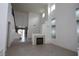 Bright living room features high ceilings, tile floors, modern fireplace, and stairway to the upper level at 3440 Crystal Tower St, Las Vegas, NV 89129