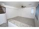 Spacious living area with tile floors, a ceiling fan, and a large window at 3440 Crystal Tower St, Las Vegas, NV 89129