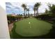 Manicured putting green surrounded by lush landscaping, providing a fun and relaxing recreational amenity at 3440 Crystal Tower St, Las Vegas, NV 89129