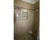 Modern shower featuring neutral tiling, built-in shelving, and updated fixtures at 3440 Crystal Tower St, Las Vegas, NV 89129