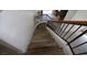Staircase with stained wood railings, wood stairs, and white walls at 3440 Crystal Tower St, Las Vegas, NV 89129
