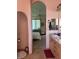 A pink themed bathroom with a bedroom viewable through a arched doorway at 3551 Sagebrush Ave, Pahrump, NV 89048