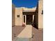 Covered front entrance with red rock landscaping and a slate tile path leading to the front door at 3551 Sagebrush Ave, Pahrump, NV 89048