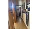 Hallway features tiled flooring and multiple framed pictures on the wall at 3551 Sagebrush Ave, Pahrump, NV 89048