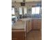 Kitchen with an island counter, wood cabinets, and matching tile backsplash at 3551 Sagebrush Ave, Pahrump, NV 89048