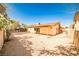 A spacious backyard featuring desert landscaping and a covered patio at 3596 Bronco Rd, Las Vegas, NV 89103