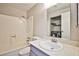 Bright bathroom featuring a shower-tub combo and a vanity sink with washer/dryer in the background at 3596 Bronco Rd, Las Vegas, NV 89103