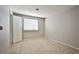 This bedroom features tile floors, a window for natural light, and neutral paint at 3596 Bronco Rd, Las Vegas, NV 89103
