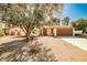 Charming single-story home with a mature tree in the front yard and a two-car garage at 3596 Bronco Rd, Las Vegas, NV 89103