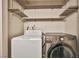This is a well-equipped laundry room with modern washer and dryer, plus shelving at 3596 Bronco Rd, Las Vegas, NV 89103