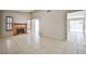 Living area featuring a brick fireplace, tile floors, and natural light streaming through the windows at 3596 Bronco Rd, Las Vegas, NV 89103