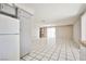 An open-concept living and dining area with tile floors and natural light at 3596 Bronco Rd, Las Vegas, NV 89103