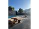 Community pool offers a refreshing escape with picnic tables under a clear sky at 3692 Garden South Dr # 0, Las Vegas, NV 89121