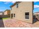 Rear exterior featuring a brick patio, green lawn, and view of surrounding homes at 3855 Park Field Dr, Las Vegas, NV 89120