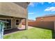 Serene backyard showcasing a manicured lawn, brick patio, and covered area for relaxation at 3855 Park Field Dr, Las Vegas, NV 89120