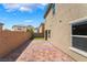 Wide brick patio and wall providing a large backyard space, with green turf at 3855 Park Field Dr, Las Vegas, NV 89120