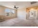 This bedroom features neutral walls, carpet, and ceiling fan with an open doorway at 3855 Park Field Dr, Las Vegas, NV 89120