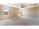 Spacious primary bedroom featuring neutral walls, plush carpet, a ceiling fan, and natural light at 3855 Park Field Dr, Las Vegas, NV 89120