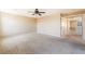 Large primary bedroom with neutral walls, ceiling fan, carpet flooring, and open doorway at 3855 Park Field Dr, Las Vegas, NV 89120