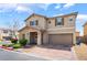 Inviting two-story home featuring desert landscaping and a brick paved driveway to a two car garage at 3855 Park Field Dr, Las Vegas, NV 89120