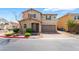 Inviting two-story home featuring desert landscaping and a brick paved driveway to a two car garage at 3855 Park Field Dr, Las Vegas, NV 89120
