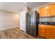 Kitchen featuring stainless steel refrigerator, wooden cabinets and countertops with wood-look vinyl flooring at 3855 Park Field Dr, Las Vegas, NV 89120