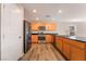 Charming kitchen features stainless steel appliances, ample wood cabinets, and black countertops at 3855 Park Field Dr, Las Vegas, NV 89120