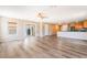Expansive living room boasts an open floorplan, hardwood flooring, sliding glass doors, and recessed lighting at 3855 Park Field Dr, Las Vegas, NV 89120