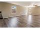 Open living room with recessed lighting, wood flooring, base molding, and two windows with natural light at 3855 Park Field Dr, Las Vegas, NV 89120