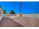 A large backyard with rock landscaping is surrounded by tall block fencing at 4010 Herblinda Ln, North Las Vegas, NV 89032