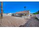 A clear view of the home's backyard showing its spacious size, patio, and minimal landscaping at 4010 Herblinda Ln, North Las Vegas, NV 89032