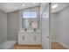 Stylish bathroom with double vanity, grey tiling, and walk-in shower at 4010 Herblinda Ln, North Las Vegas, NV 89032