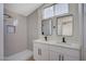 Contemporary bathroom with double sinks and a sleek, tiled walk-in shower at 4010 Herblinda Ln, North Las Vegas, NV 89032