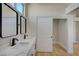 Modern bathroom featuring a double vanity and convenient closet access at 4010 Herblinda Ln, North Las Vegas, NV 89032