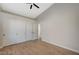 Bright bedroom features light wood floors, vaulted ceiling, and closet with white sliding doors at 4010 Herblinda Ln, North Las Vegas, NV 89032