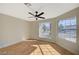 Bright bedroom with new floors, ceiling fan, and large windows offering plenty of natural light at 4010 Herblinda Ln, North Las Vegas, NV 89032
