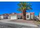 Inviting single-story home featuring mature palm trees, low maintenance landscaping, and a two car garage at 4010 Herblinda Ln, North Las Vegas, NV 89032