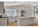 Bright, updated kitchen features stainless appliances, a kitchen island with white cabinets, and generous natural light at 4010 Herblinda Ln, North Las Vegas, NV 89032