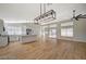 Bright and open living space featuring a modern kitchen, island, wood flooring, and plenty of natural light at 4010 Herblinda Ln, North Las Vegas, NV 89032