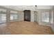 Spacious living room with wood floors, and a dark accent wall featuring an electric fireplace at 4010 Herblinda Ln, North Las Vegas, NV 89032