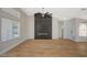 Open living space with wood floors, dark feature wall, fireplace, and ample natural light at 4010 Herblinda Ln, North Las Vegas, NV 89032