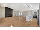Spacious living room featuring new floors, vaulted ceiling, fireplace, and modern kitchen with stainless appliances at 4010 Herblinda Ln, North Las Vegas, NV 89032