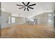 Open concept living space with new floors, modern lighting, vaulted ceilings, and a view into the modern kitchen at 4010 Herblinda Ln, North Las Vegas, NV 89032
