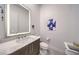 Contemporary bathroom with vanity, toilet, white marble wall decor, and backlit mirror at 461 Highview Ridge Ave, Las Vegas, NV 89138