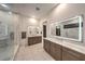 Modern bathroom featuring dual vanities, illuminated mirrors, and a glass enclosed shower at 461 Highview Ridge Ave, Las Vegas, NV 89138