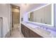 Modern bathroom featuring a double sink vanity with an illuminated mirror and a separate shower/tub at 461 Highview Ridge Ave, Las Vegas, NV 89138