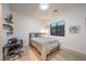 Minimalist bedroom with light wood floors, a full-sized bed, a work desk, and simple decor at 461 Highview Ridge Ave, Las Vegas, NV 89138